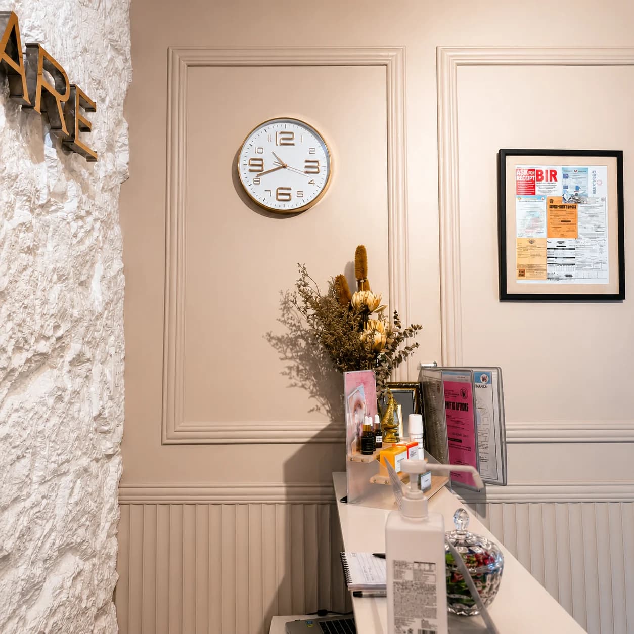 ESCLARE Naga front desk with warm wall mouldings and clinic permits